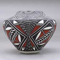 A polychrome jar decorated with a fineline, spiral, feather and geometric design, click or tap to see a larger version