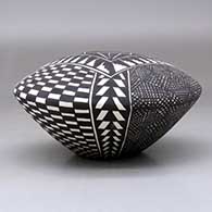 A polychrome seed pot decorated with a checkerboard, fineline and geometric design, click or tap to see a larger version