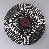 A polychrome seed pot decorated with a checkerboard, fineline and geometric design, click or tap to see a larger version