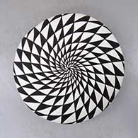 A black on white seed pot decorated with a spiral mesa geometric design
 by Sandra Victorino of Acoma