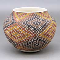 A polychrome jar decorated with a diamond tiny squares and geometric design
 by Frederica Antonio of Acoma