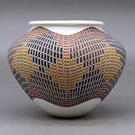 A polychrome jar with a a rolled lip and decorated with a tiny squares geometric design, click or tap to see a larger version