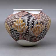 A polychrome jar with a a rolled lip and decorated with a tiny squares geometric design, click or tap to see a larger version