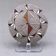 A polychrome seed pot decorated above the shoulder with a snowflake fineline and geometric design
 by Shaylene Chino of Acoma