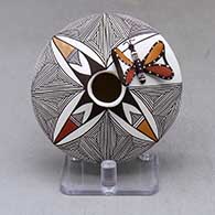A polychrome seed pot decorated above the shoulder with a fineline and geometric design plus a painted butterfly applique
 by George Concho Jr of Acoma