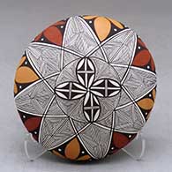 A polychrome seed pot decorated above the shoulder with a snowflake fineline and geometric design plus a butterfly applique on the back
 by Alisha Sanchez of Acoma