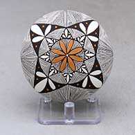 A polychrome seed pot decorated with a fineline and geometric design above the shoulder and with a painted butterfly applique on the back
 by Alisha Sanchez of Acoma