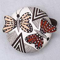 A miniature polychrome seed pot decorated with painted butterfly appliques and a fineline and geometric design
 by Alisha Sanchez of Acoma