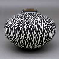 A black on white jar decorated with a lightning bolt geometric design
 by Paula Estevan of Acoma