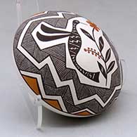 A polychrome seed pot decorated above the shoulder with a hummingbird, flower, fineline and geometric design, click or tap to see a larger version