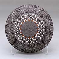 A polychrome seed pot decorated above the shoulder with a North Star fineline and geometric design
 by Rebecca Lucario of Acoma