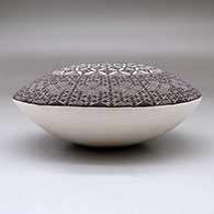 A black on white seed pot decorated above the shoulder with a North Star fineline and geometric design, click or tap to see a larger version