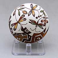 A miniature polychrome seed pot decorated above the shoulder with a dragonfly, plant, fineline and geometric design
 by Diane Lewis of Acoma