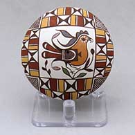 A miniature polychrome seed pot decorated above the shoulder with a parrot, branch and geometric design
 by Diane Lewis of Acoma