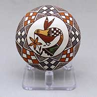 A miniature polychrome seed pot decorated above the shoulder with a hummingbird, flower and geometric design
 by Diane Lewis of Acoma