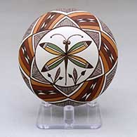 A polychrome seed pot decorated above the shoulder with a dragonfly, plant and geometric design
 by Diane Lewis of Acoma