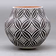 A small polychrome jar decorated with a two panel spiral mesa, fineline and geometric design, click or tap to see a larger version