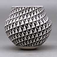 A small polychrome jar decorated with a two panel spiral mesa, fineline and geometric design, click or tap to see a larger version