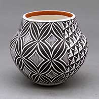 A small polychrome jar decorated with a two panel spiral mesa, fineline and geometric design
 by Frederica Antonio of Acoma