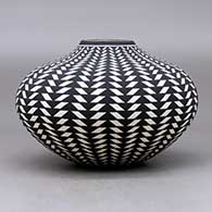 A black on white jar decorated with a basket weave geometric design, click or tap to see a larger version