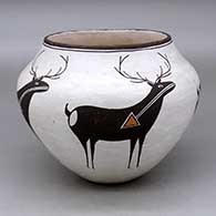 A polychrome jar decorated with a four panel deer with heart line design
 by Lucy Lewis of Acoma