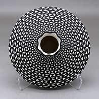 A black on white low shouldered jar with a pie crust rim and decorated with a geometric design
 by Paula Estevan of Acoma