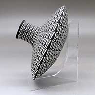 A black on white low shouldered jar decorated with a geometric design, click or tap to see a larger version