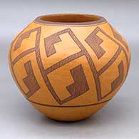 A black on orange jar decorated with a locks-and-keys geometric design
 by Robert Patricio of Acoma