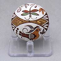 A miniature polychrome seed pot decorated with a parrot, dragonfly, flower, fineline and geometric design
 by Diane Lewis of Acoma