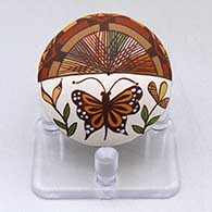 A miniature polychrome seed pot decorated with a butterfly, plant, fineline and geometric design
 by Diane Lewis of Acoma