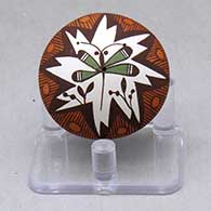 A miniature polychrome seed pot decorated with a dragonfly, flower, fineline and geometric design
 by Diane Lewis of Acoma