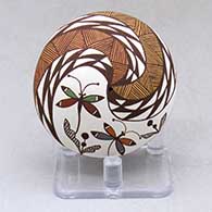 A polychrome seed pot decorated above the shoulder with a dragonflies under rain clouds geometric design
 by Diane Lewis of Acoma