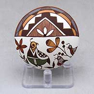 A polychrome seed pot decorated above the shoulder with a family of quail among the wildflowers under rain clouds geometric design
 by Diane Lewis of Acoma