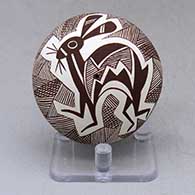 A brown on white seed pot decorated above the shoulder with a Mimbres rabbit, fineline and geometric design
 by Diane Lewis of Acoma