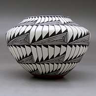 A black on white jar decorated with an eight panel fineline and geometric design, click or tap to see a larger version