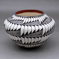 A black on white jar decorated with an eight panel fineline and geometric design
 by Sandra Victorino of Acoma