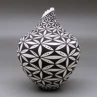 A polychrome tear drop jar with a kiva step cut opening and decorated with a pumpkin seed snowflake and geometric design, click or tap to see a larger version