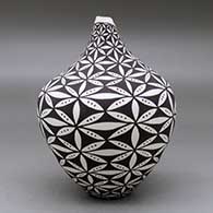 A polychrome tear drop jar with a kiva step cut opening and decorated with a pumpkin seed snowflake and geometric design, click or tap to see a larger version