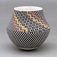 A small polychrome jar decorated with a tiny square geometric design
 by Frederica Antonio of Acoma
