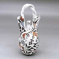 A polychrome wedding vase with a twisted bridge and decorated with cat and butterfly appliques and painted with a kokopelli, bird, lizard and geometric design
 by Judy Lewis of Acoma