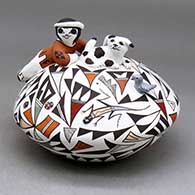 A polychrome seed pot decorated with child, puppy, lady bug, bird and lizard head appliques, and painted with a lizard and geometric design
 by Judy Lewis of Acoma