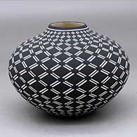 A black on white jar decorated with a diagonal geometric design
 by Paula Estevan of Acoma