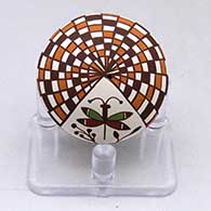 A miniature polychrome seed pot decorated with a dragonfly, plant and checkerboard geometric design
 by Diane Lewis of Acoma