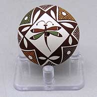 A miniature polychrome seed pot decorated with a dragonfly, fineline and geometric design
 by Diane Lewis of Acoma