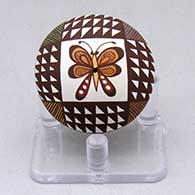 A miniature polychrome seed pot decorated with a butterfly, fineline and geometric design
 by Diane Lewis of Acoma