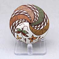 A polychrome seed pot decorated with a dragonfly, flower, rain cloud and geometric design
 by Diane Lewis of Acoma