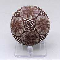 A black on white seed pot decorated with a starburst fineline, checkerboard and geometric design
 by Diane Lewis of Acoma