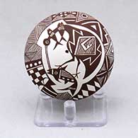 A black on white seed pot decorated with a cloudeater, fish, fineline, checkerboard and geometric design
 by Diane Lewis of Acoma