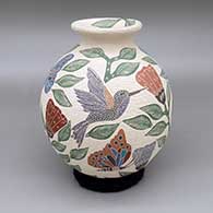 Polychrome jar with a flared opening and a sgraffito and painted hummingbird, butterfly, flower, leaf, and branch design
 by Sandra Lorena Arras of Mata Ortiz and Casas Grandes