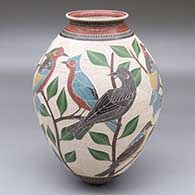 A polychrome jar with a flared lip and a sgraffito-and-painted bird, branch, leaf and geometric design
 by Jesus Olivas of Mata Ortiz and Casas Grandes